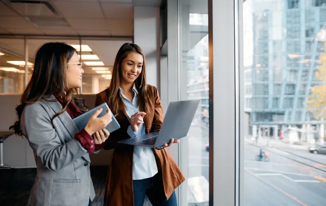 Two women with laptops