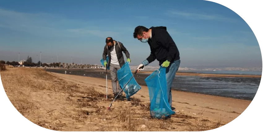 people litter picking on a beach