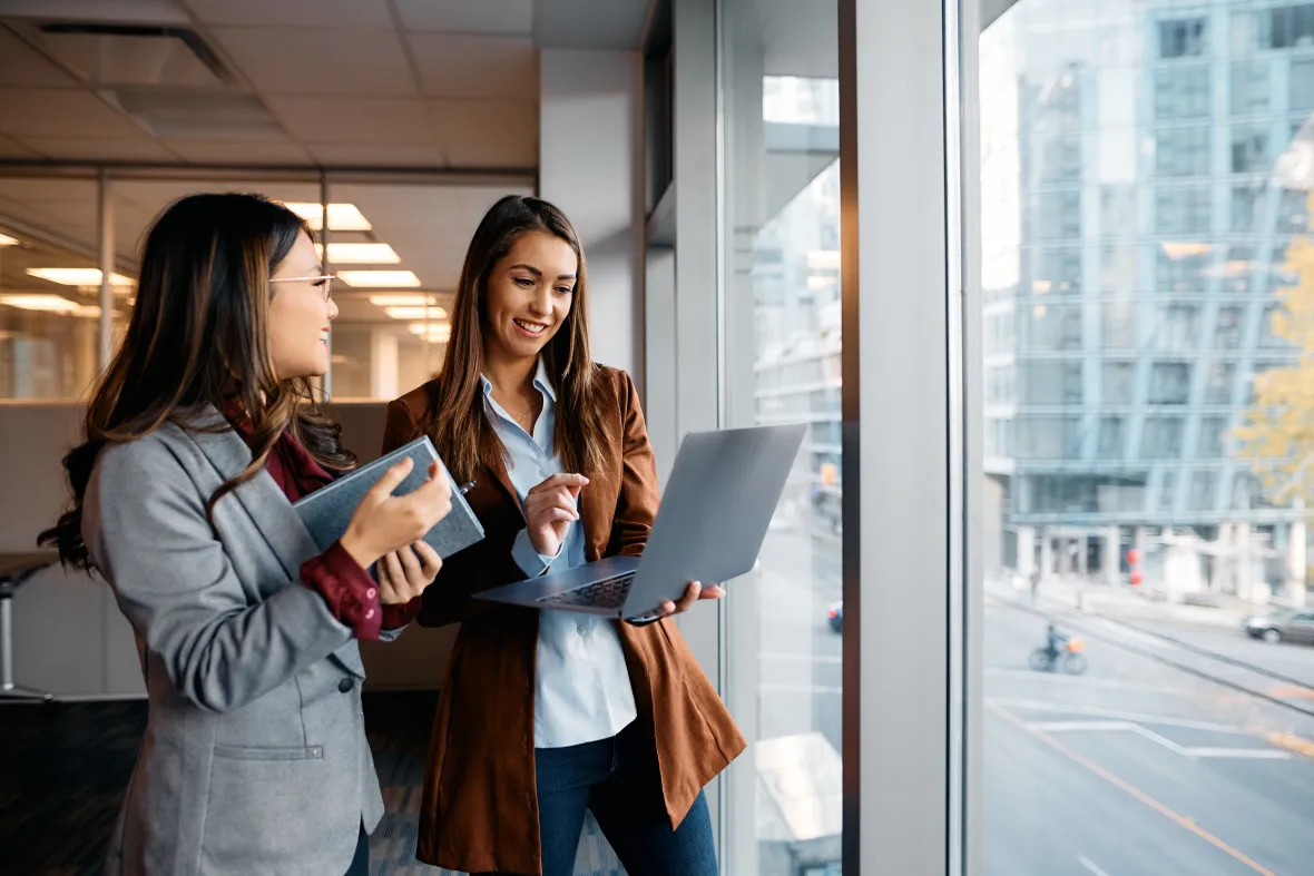 Two women with laptops